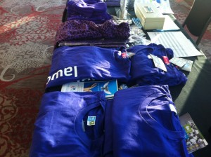 Purple clothing displayed on a table at the International Women's Day Breakfast