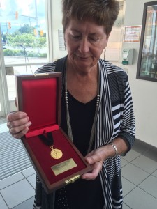 Deanne Hart reveals the Pierce Medal, presented the families of firefighters who have lost their lives in the line-of-duty