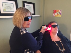 Deb Taylor, Owner of London Laser and Hypnotherapy Centre, treating a smoking patient with her laser.
