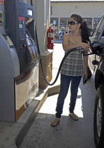 A woman pumping gas into her vehicle 